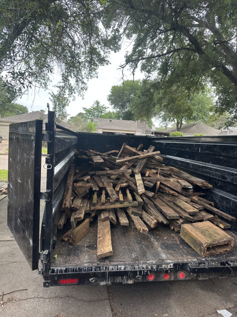 L&G Junk Removal trailer loaded with yard waste during a cleanup project in Orlando, FL.
